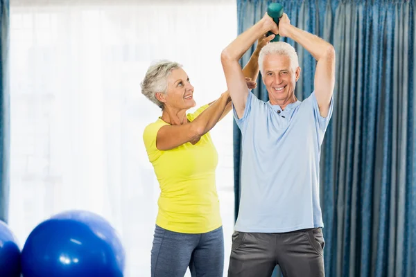 Senior man using weights