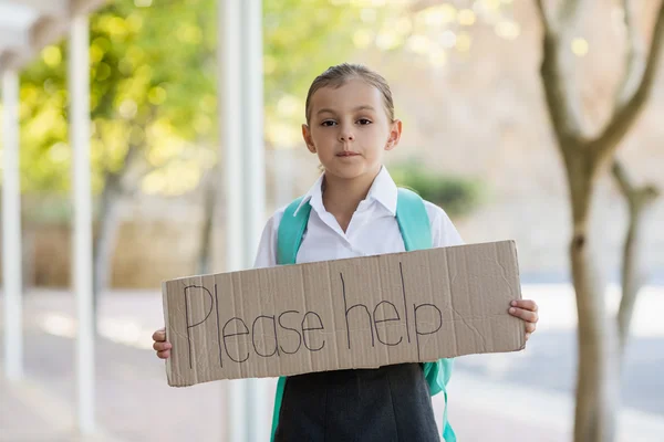 Schoolgirl holding placard