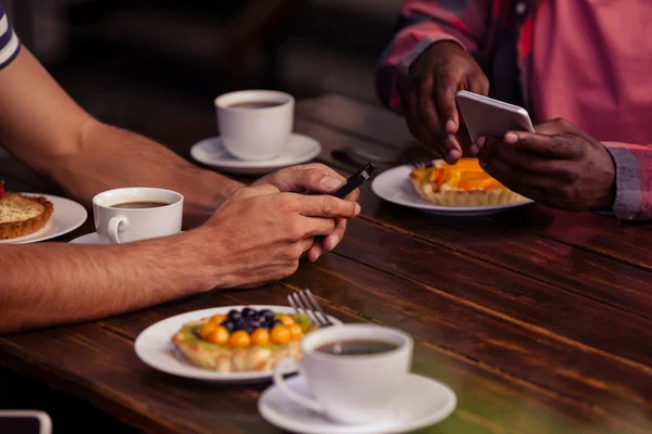 Friends eating pastries and drinking coffee