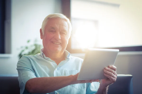 Senior man using digital tablet