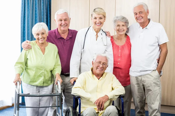 Nurse and seniors standing together