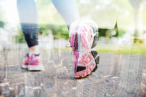 Pink sneakers against new york skyline