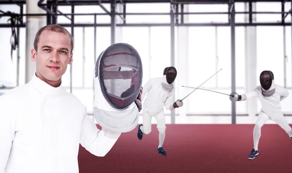 Men in fencing suits practicing with swords