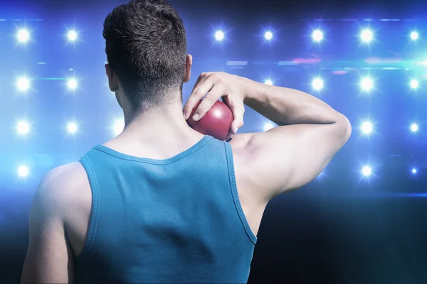 Sportsman practising shot put