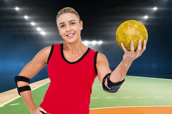 Athlete with elbow pads holding handball