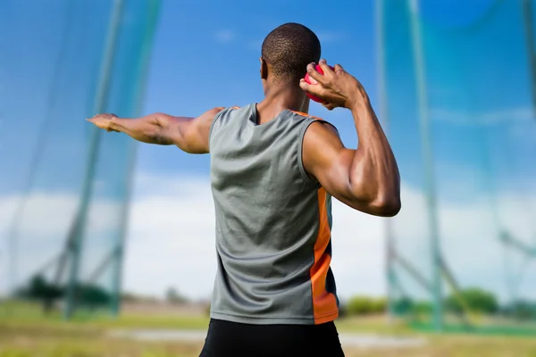 Athletic man preparing shot put