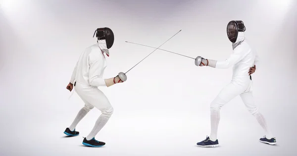 Men in fencing suits practicing with swords