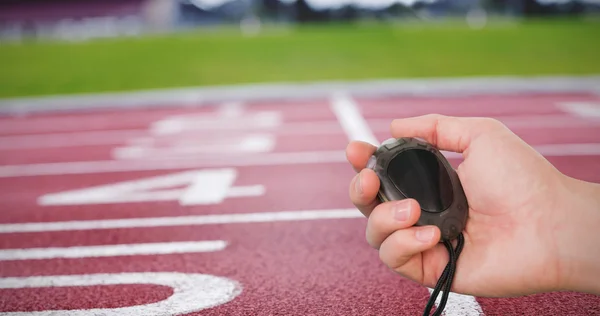 Coach holding stopwatch