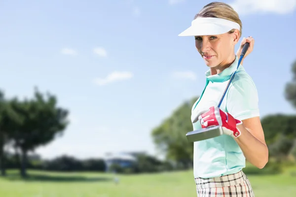 Woman golf player looking camera