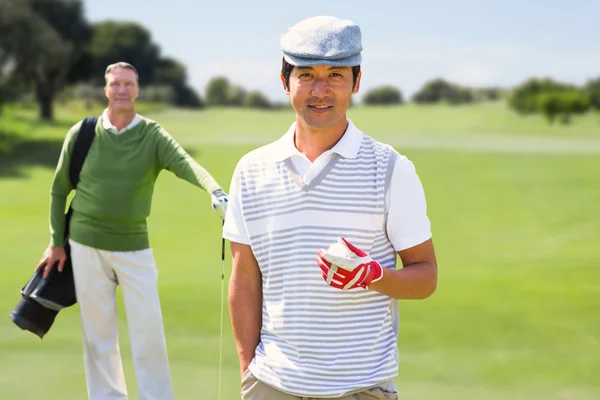 Golfing friends smiling at camera