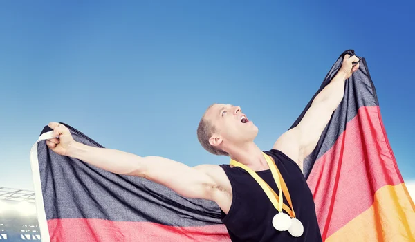 Athlete posing with olympic gold medals