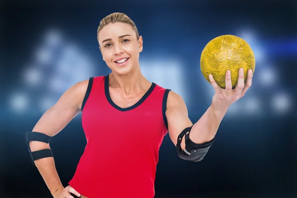 Athlete with elbow pads holding handball