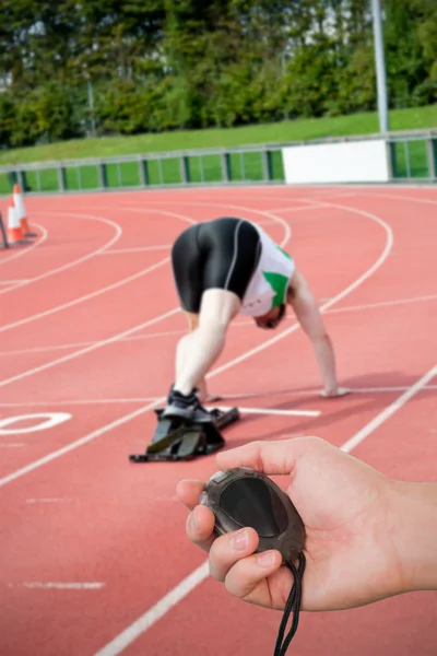 Coach holding stopwatch