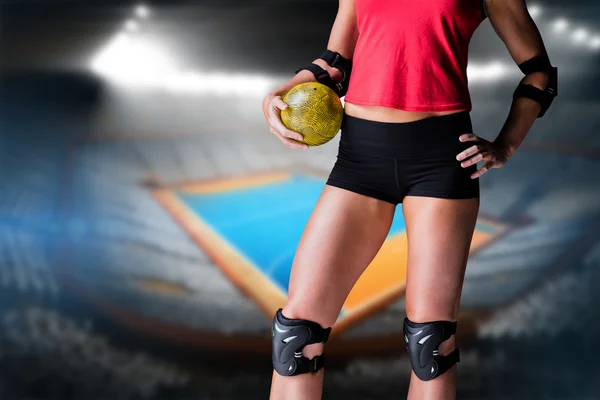 Athlete with elbow pads holding handball