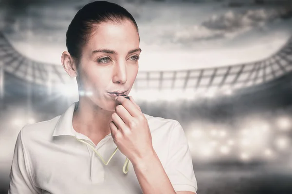 Female athlete blowing a whistle