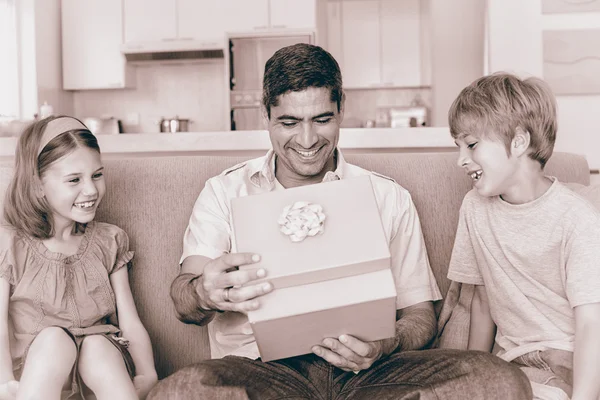 Father opening gift given by children