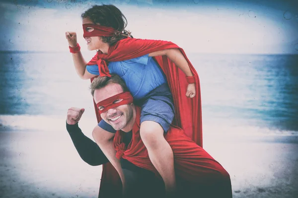 Father and son in superhero costume