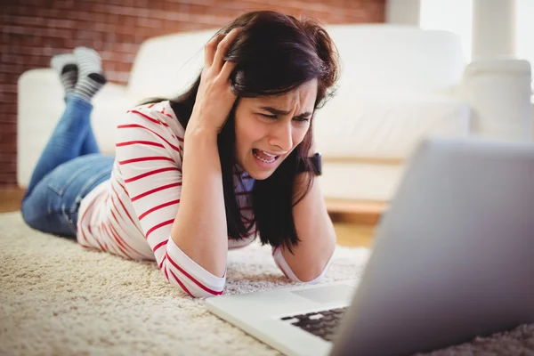 Frustrated woman using laptop