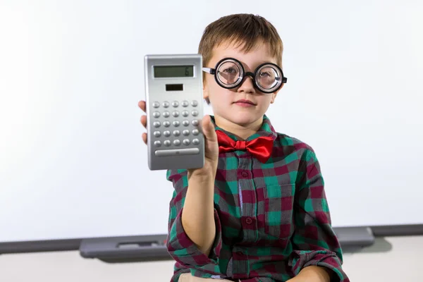 Elementary boy holding calculator