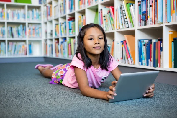 Girl holding tablet in school library