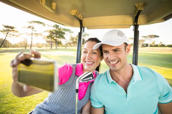 Golfer couple taking self portrait