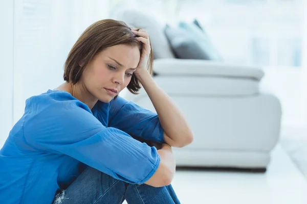 Depressed woman sitting at home