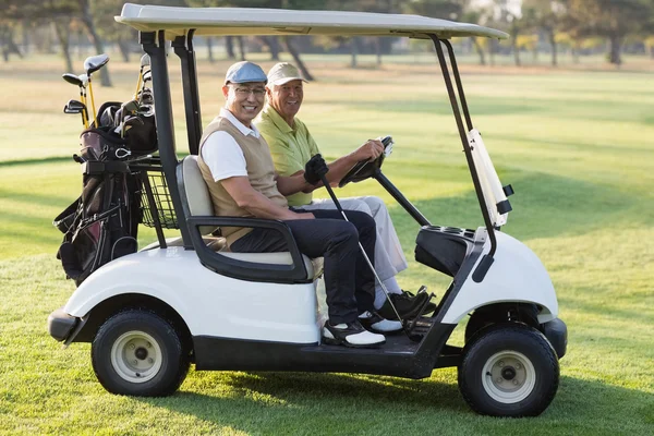 Male golfer friends sitting in golf buggy