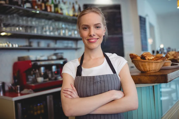 Waitress with arms crossed at cafe