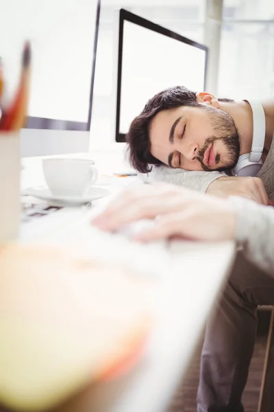 Tired businessman taking nap in office