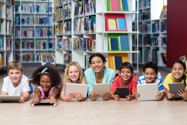 Teacher with students using digital tablets