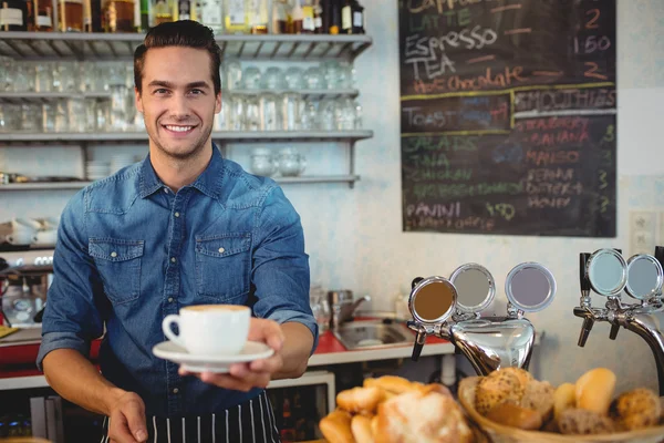 Owner offering coffee at cafeteria