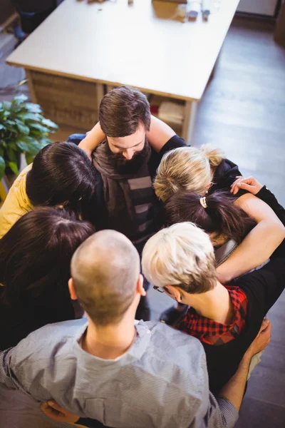 Business people forming huddle in office