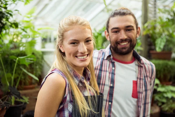 Happy gardeners at greenhouse