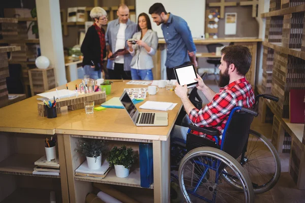 Disabled businessman using tablet