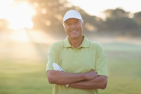 Smiling golfer with arms crossed