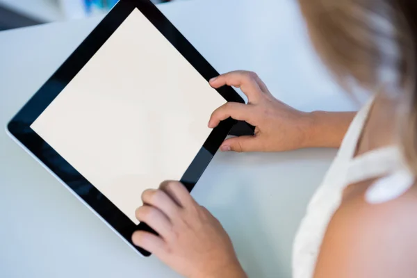 Girl using digital tablet in library