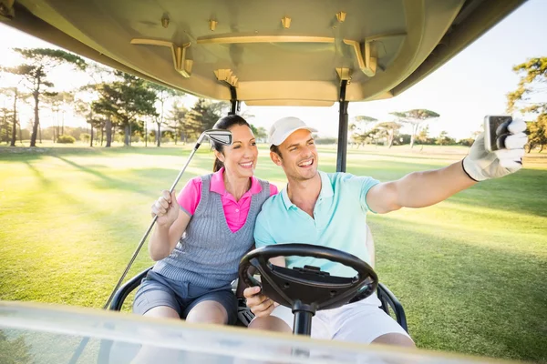 Golfer couple taking self portrait