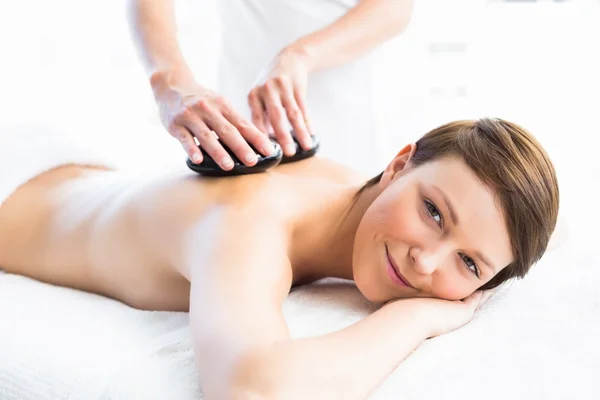 Woman receiving hot stone massage