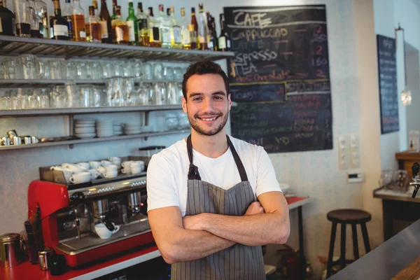 Barista with arms crossed at coffee shop