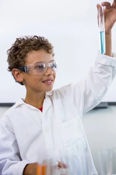 Boy holding test tube with liquid