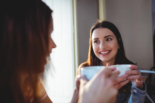 Beautiful woman with friend at cafeteria