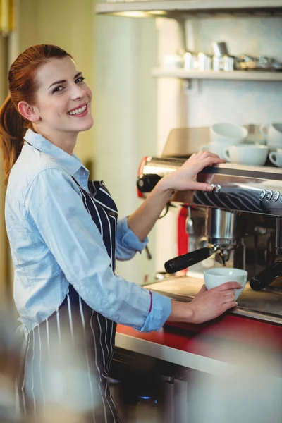 Waitress using espresso machine