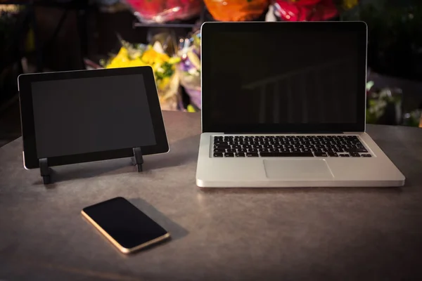 Laptop, digital tablet and mobile phone on the table
