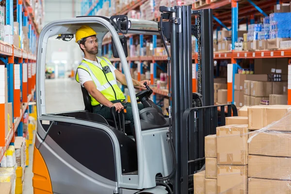 Worker is driving a pallet truck