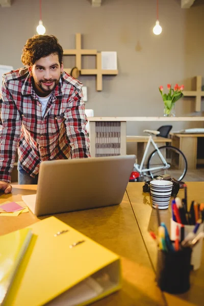 Portrait of graphic designer working on laptop