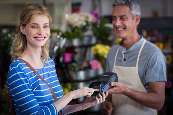 Smiling woman making payment with her credit card