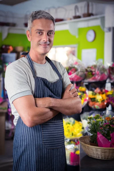 Male florist standing with arms crossed