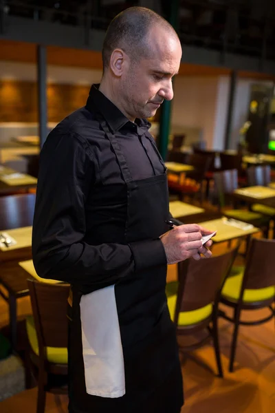 Waiter writing order on notepad