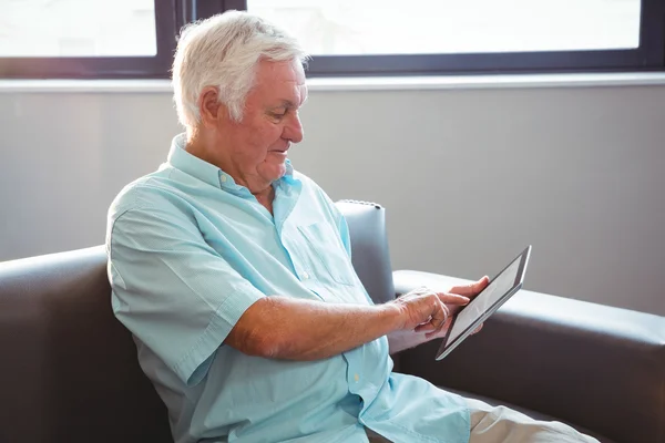 Senior man using a digital tablet