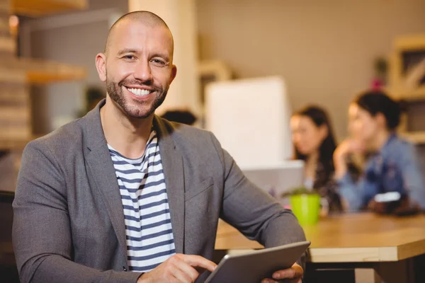 Portrait of male graphic designer using digital tablet